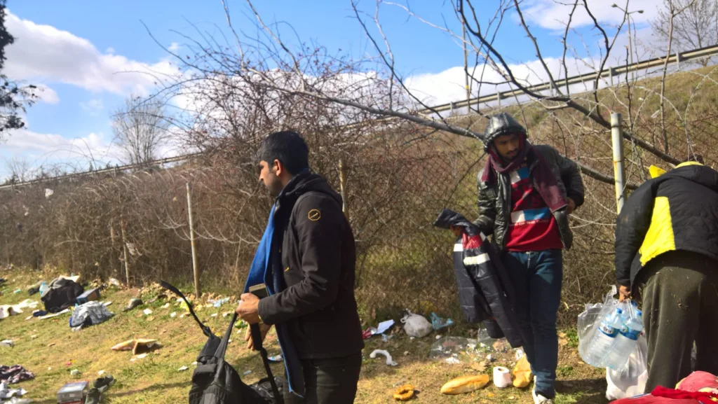 Migrants gathered at the camp's exit, ready to cross to Greece